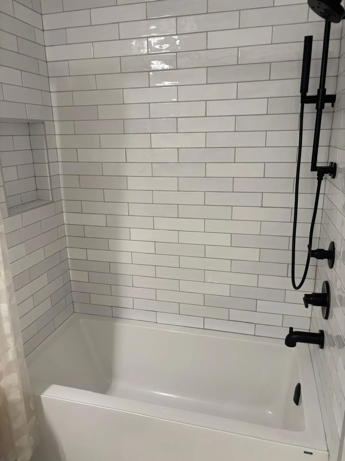 Tiled bathtub and shower with black fixtures
